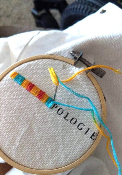 colorful stitching covering the logo