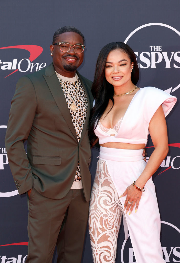 A closeup of Lil Rel and Dannella smiling for photographers on the red carpet at The Espys