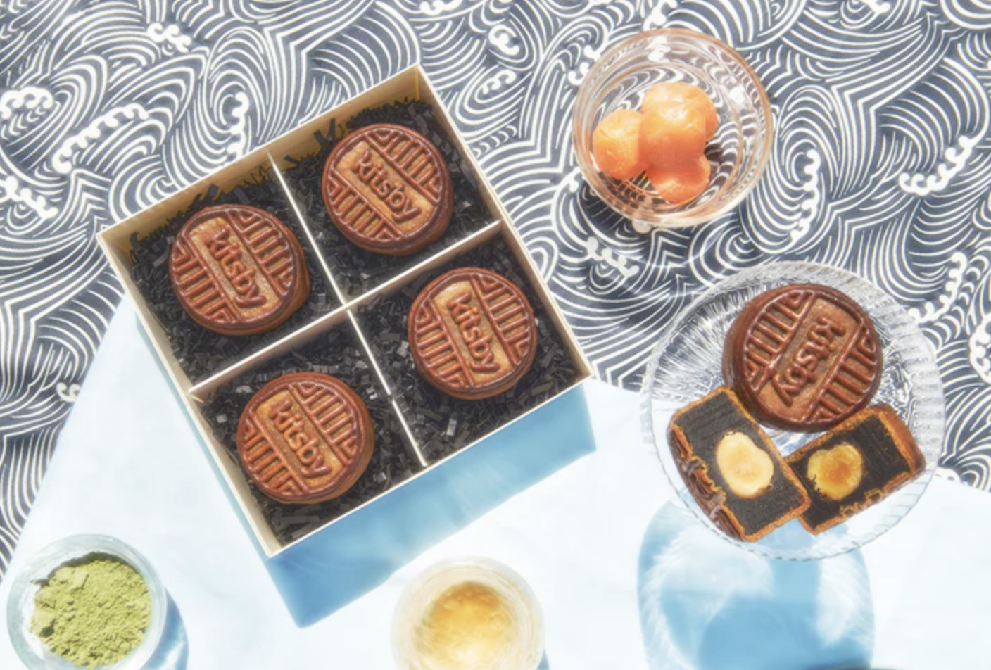 Four mooncakes with the word Kitsby stamped across in a box.