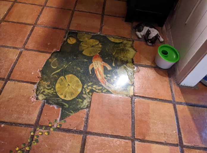pond and fish scene painted into missing tiles on the floor