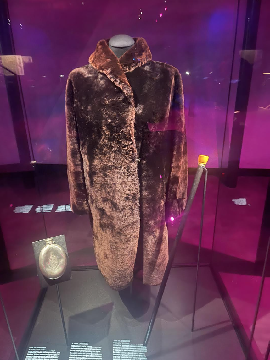 the coat on display next to a flask