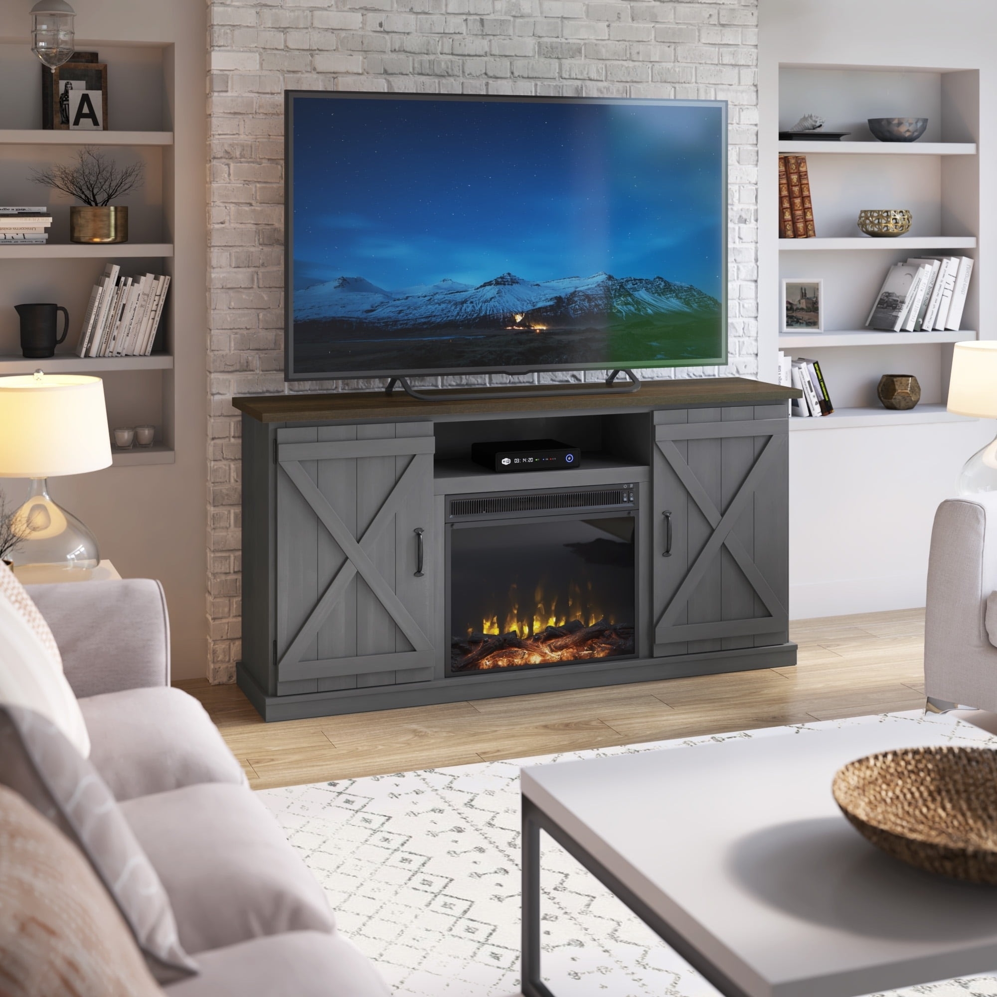 An electric fireplace console with a tv on top