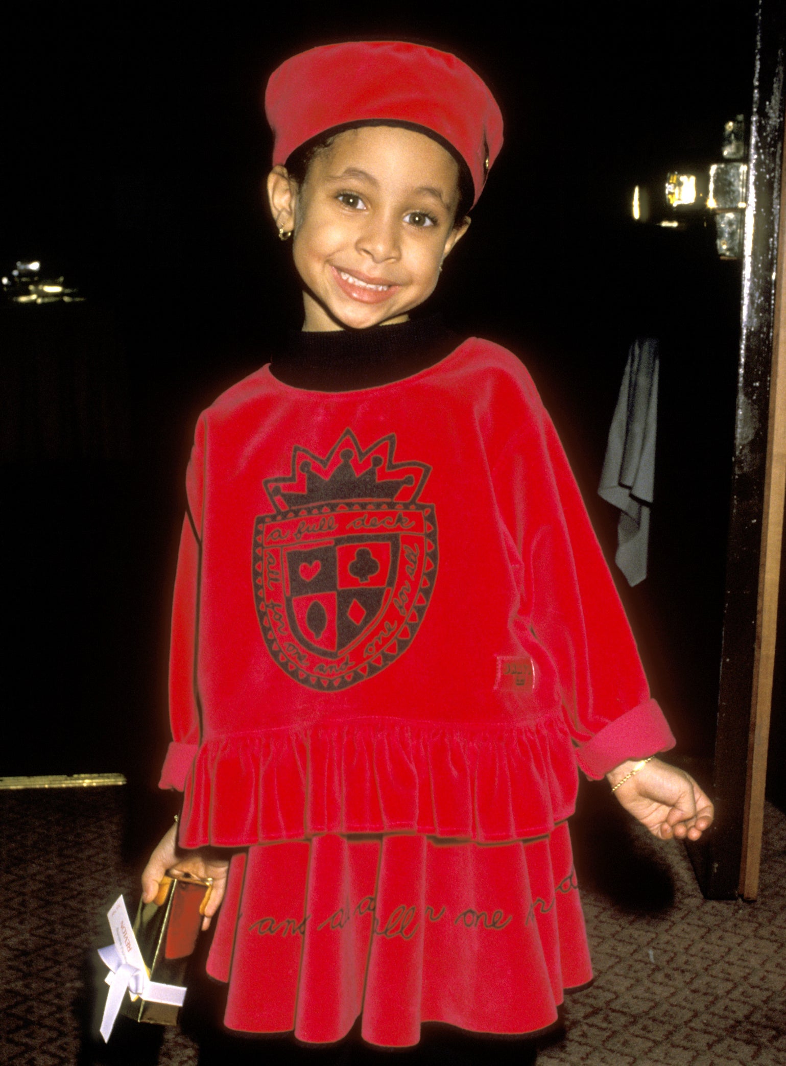 Smiling Raven in a matching skirt set and hat