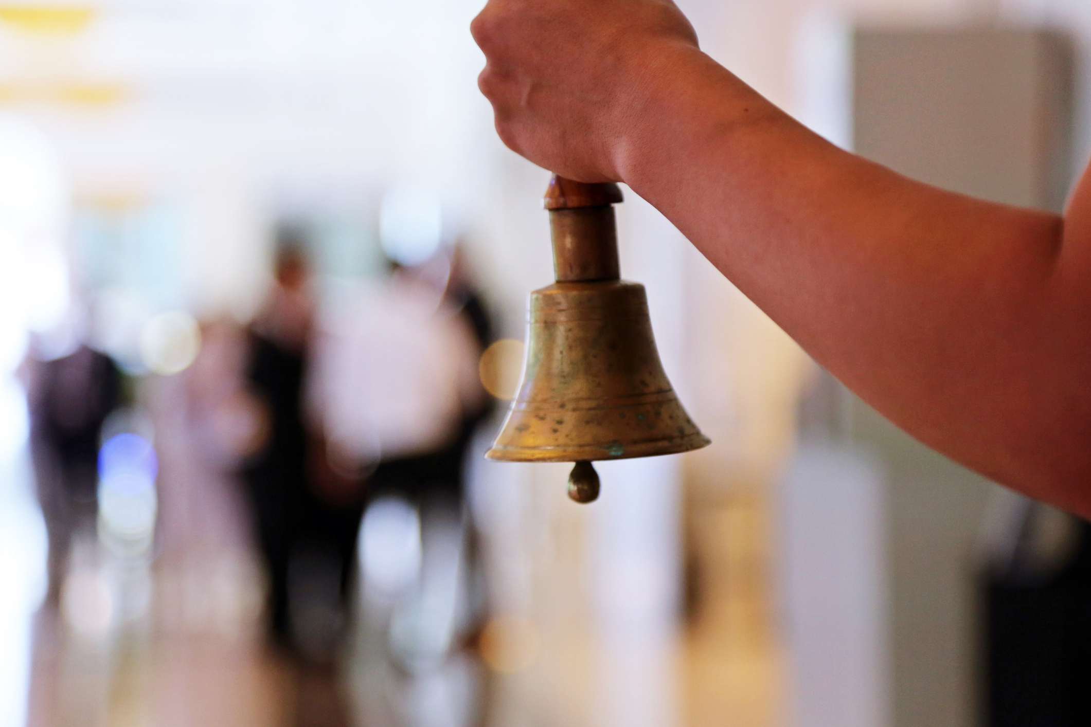 Teacher holding a school bell