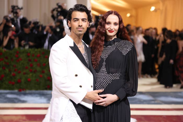 Joe Jonas and Sophie Turner cradling her baby bump on the red carpet