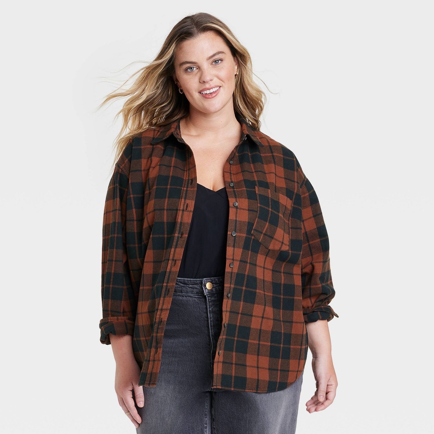 A model wearing the flannel in brown plaid