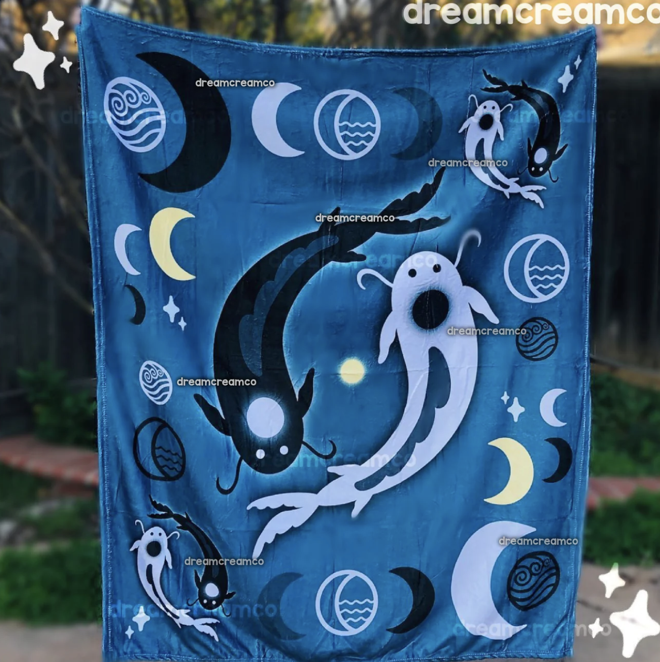 Blue plush blanket with koi fish and moon designs.