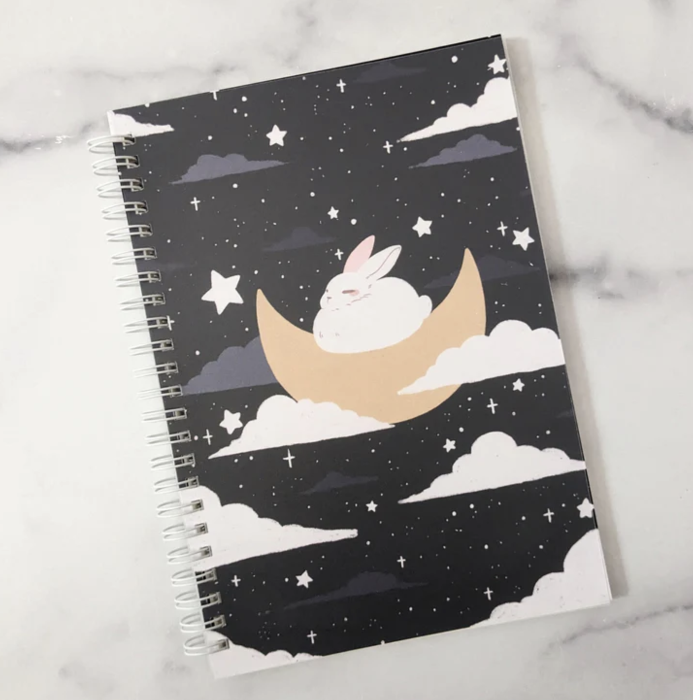 Spiral sticker book featuring bunny sleeping on a crescent moon.