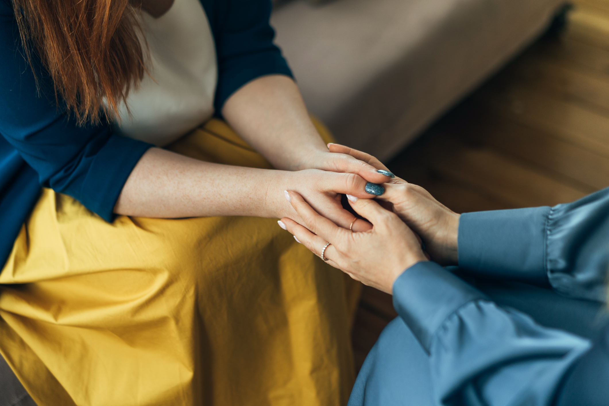Two people are holding hands while counseling each other