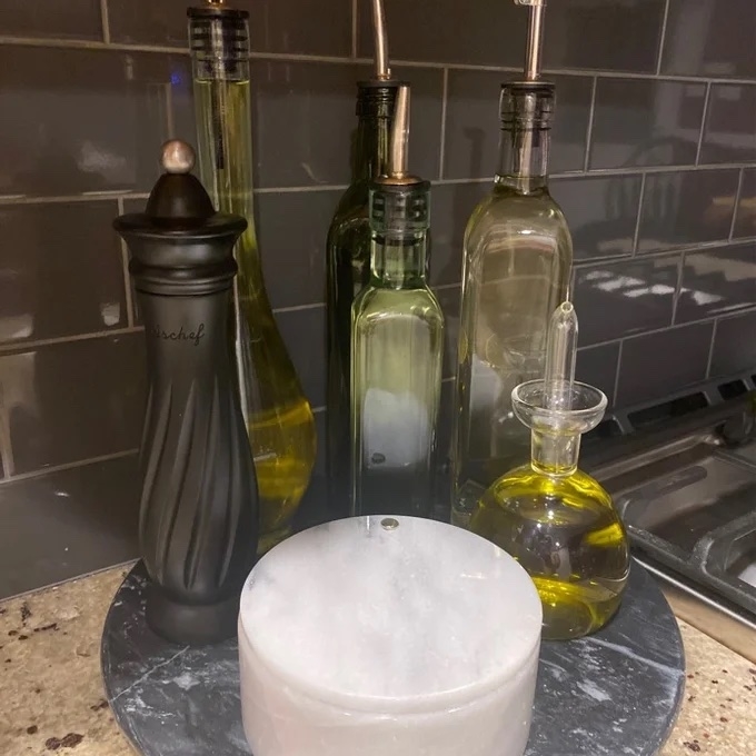 Reviewer image of the marble lazy Susan with oils and salt next to the stove