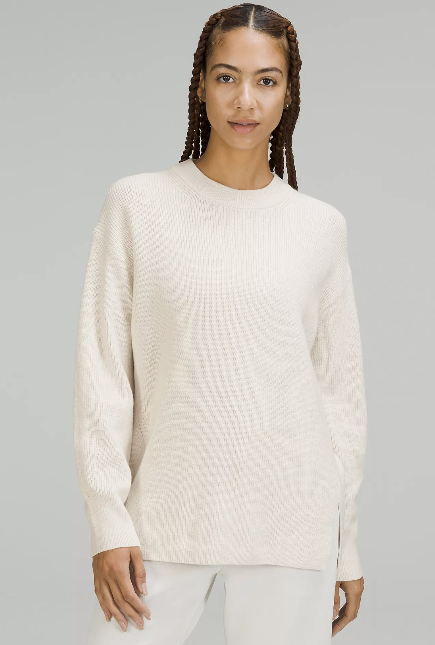 a model wearing the sweater in white