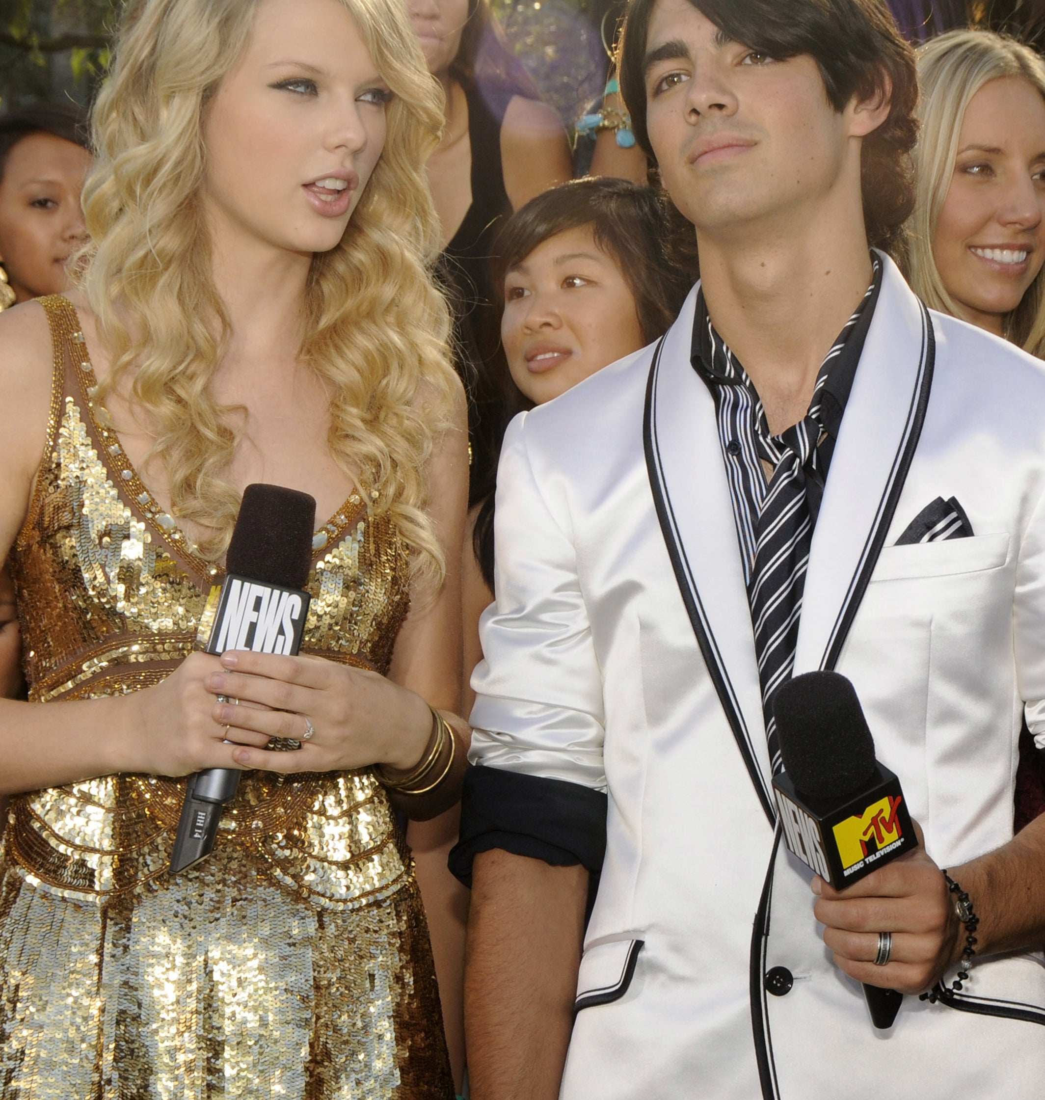 Close-up of Taylor and Joe holding microphones