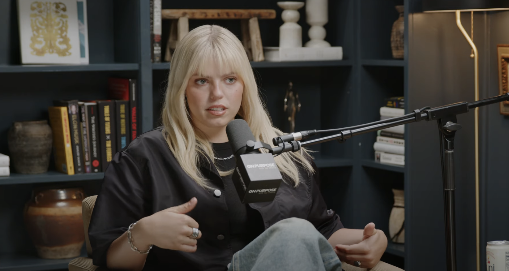 Close-up of Reneé seated and talking into a microphone