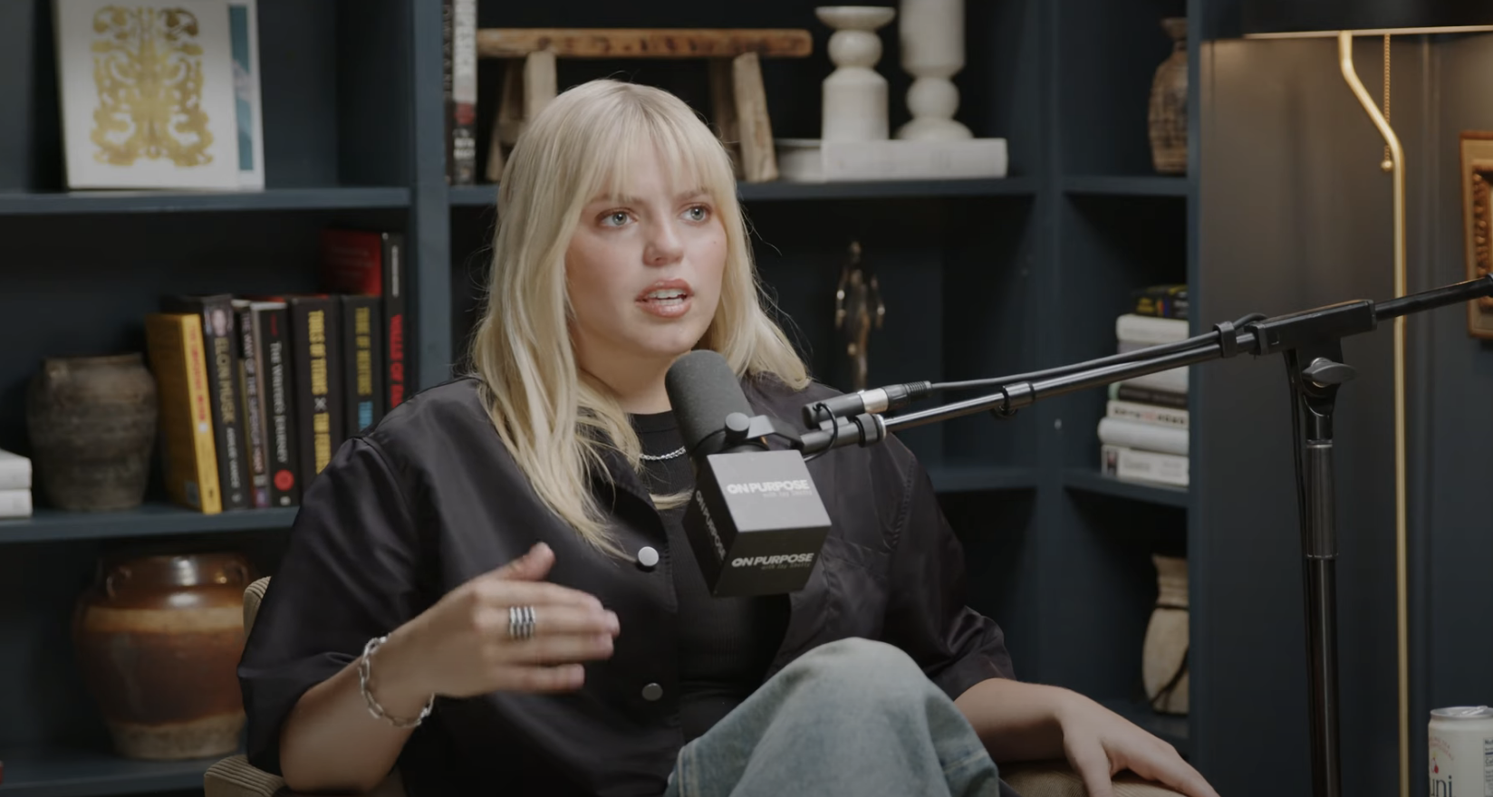 Close-up of Reneé seated and talking into a microphone