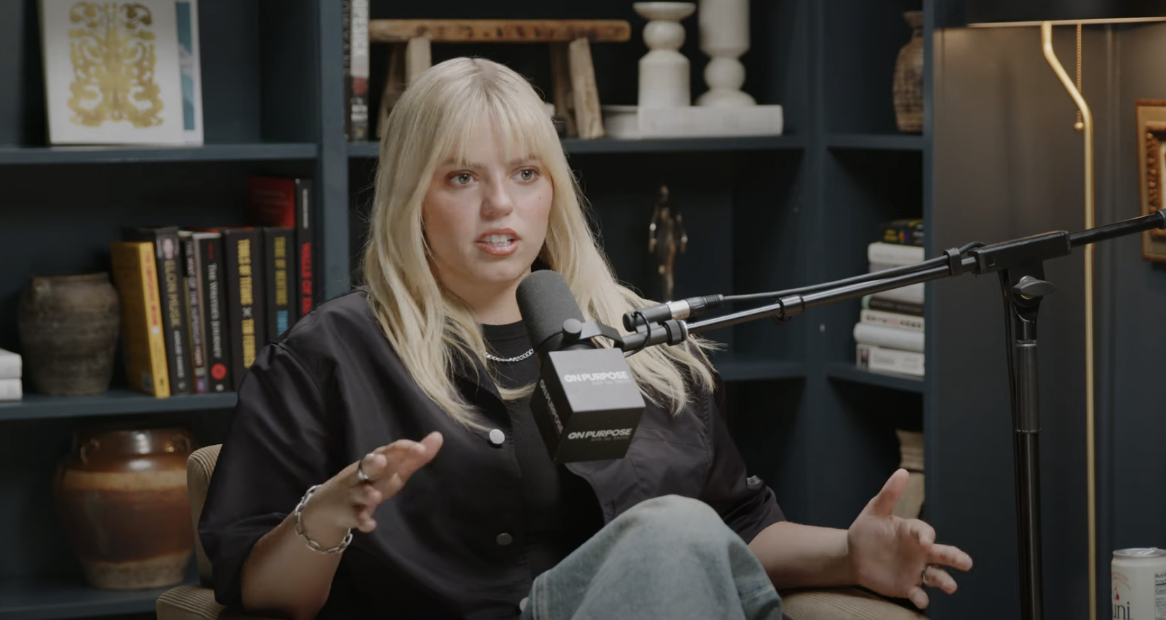 Close-up of Reneé seated and talking into a microphone