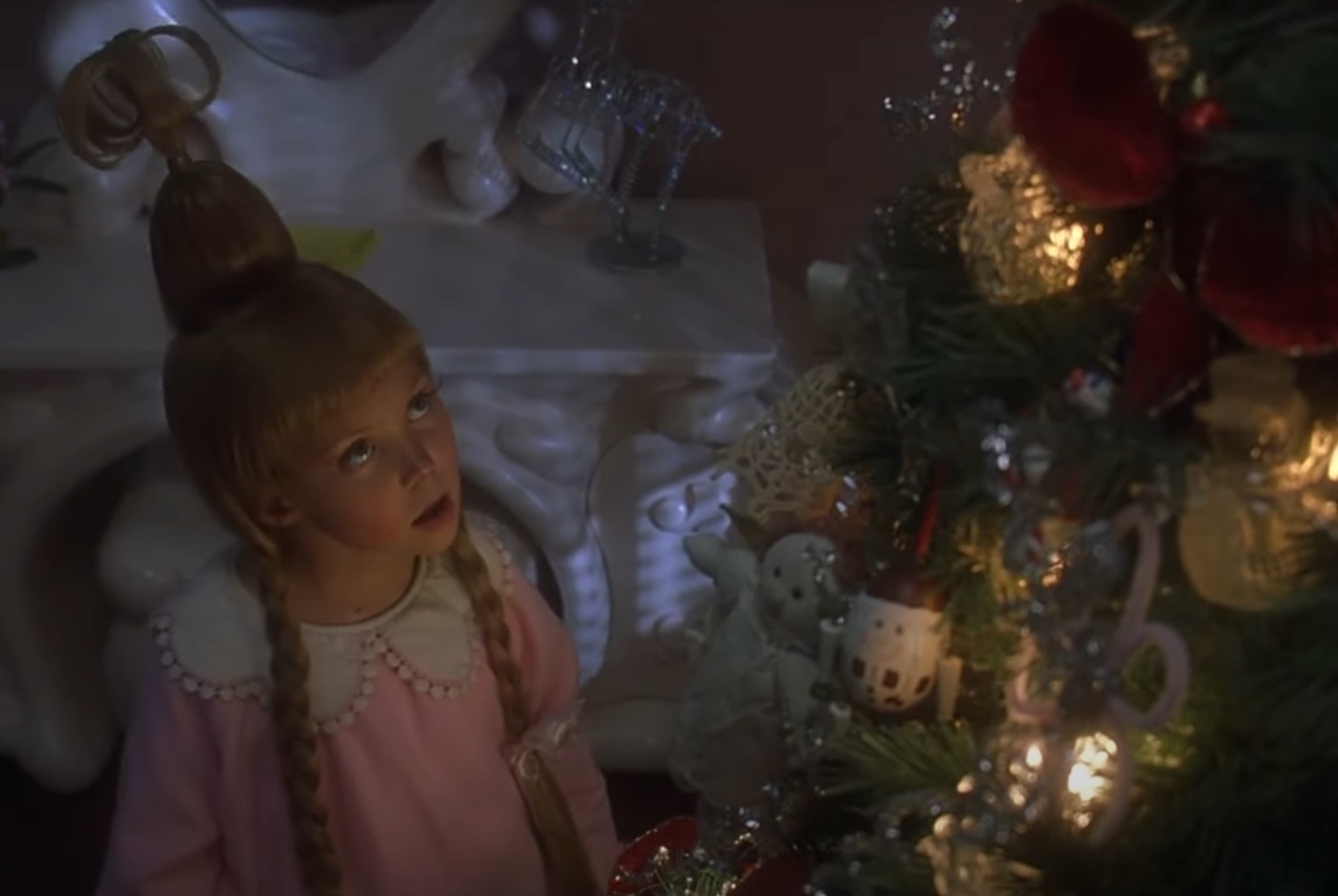 Taylor&#x27;s character looking up at a Christmas tree