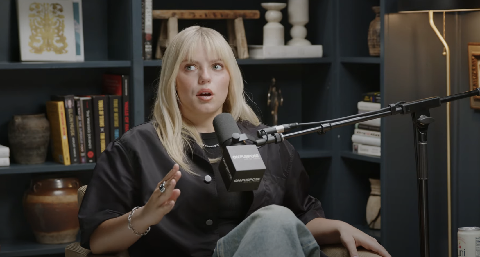 Close-up of Reneé seated and talking into a microphone