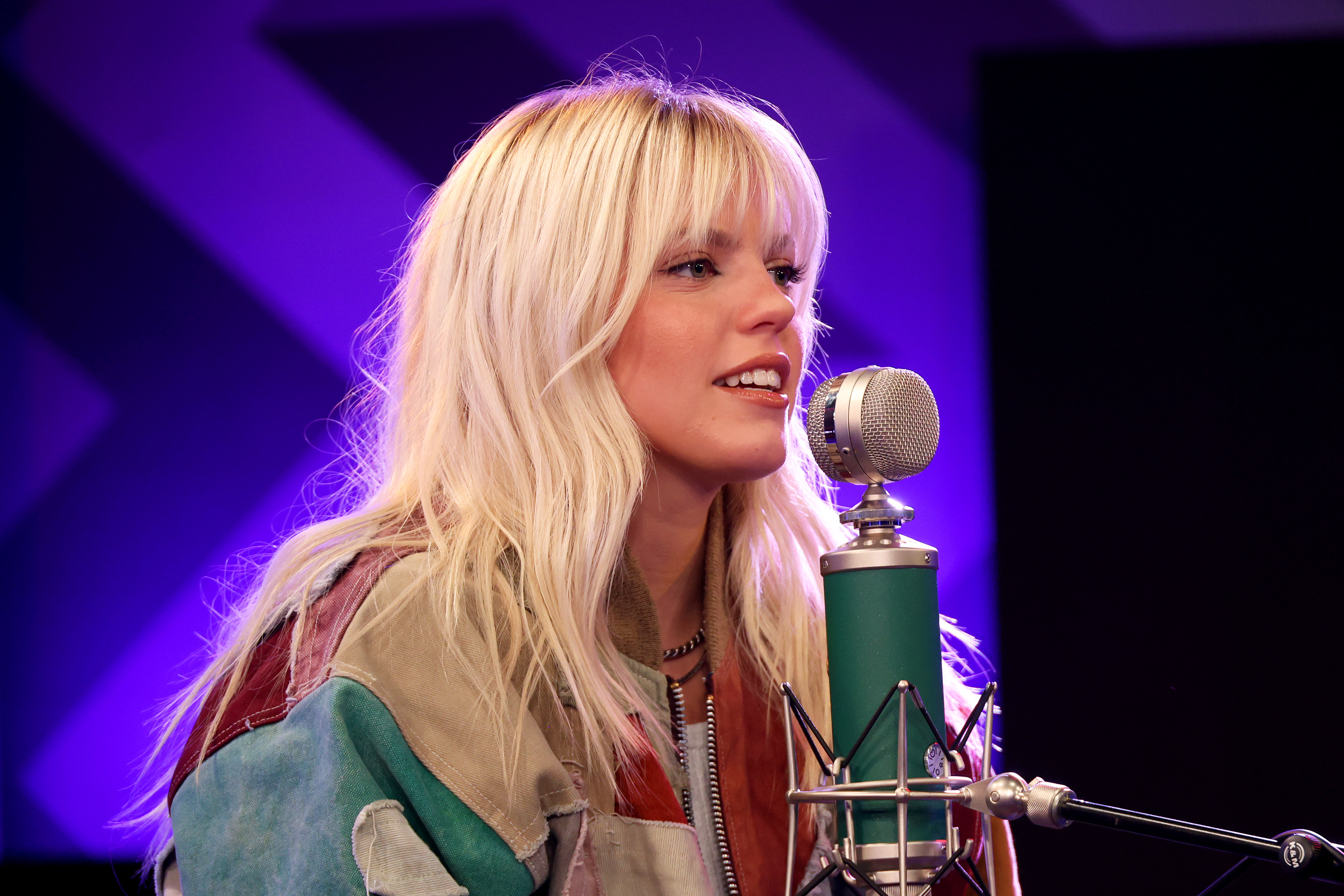 Close-up of Reneé talking into a microphone