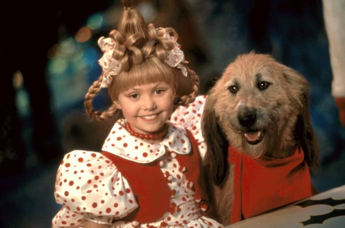 Taylor Momsen in character as cindy lou who with a dog in the grinch