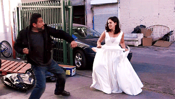 Amy catching a criminal in her wedding dress.