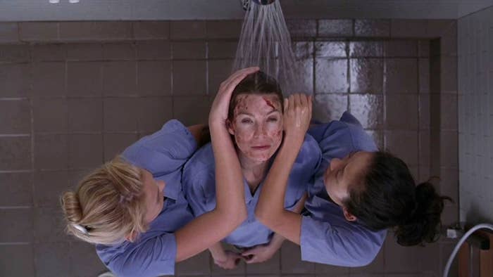 Izzie and Cristina, washing Meredith who has blood on her.