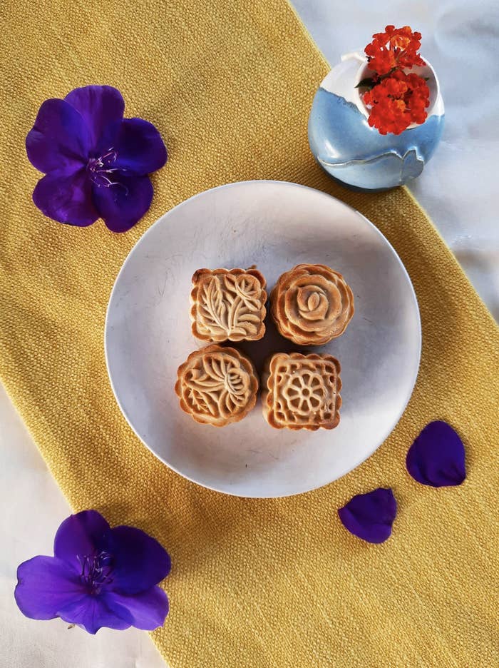 Four floral designed mooncakes on a plate