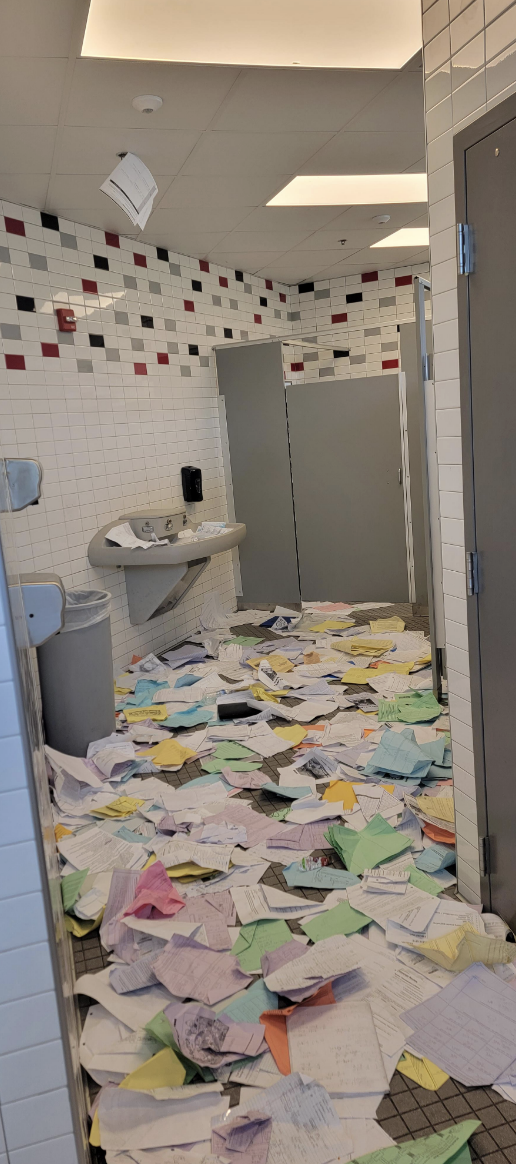 A bathroom with trash all over the floor