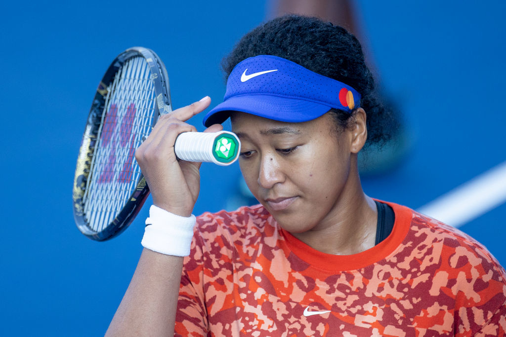 Naomi Osaka holding a tennis racket