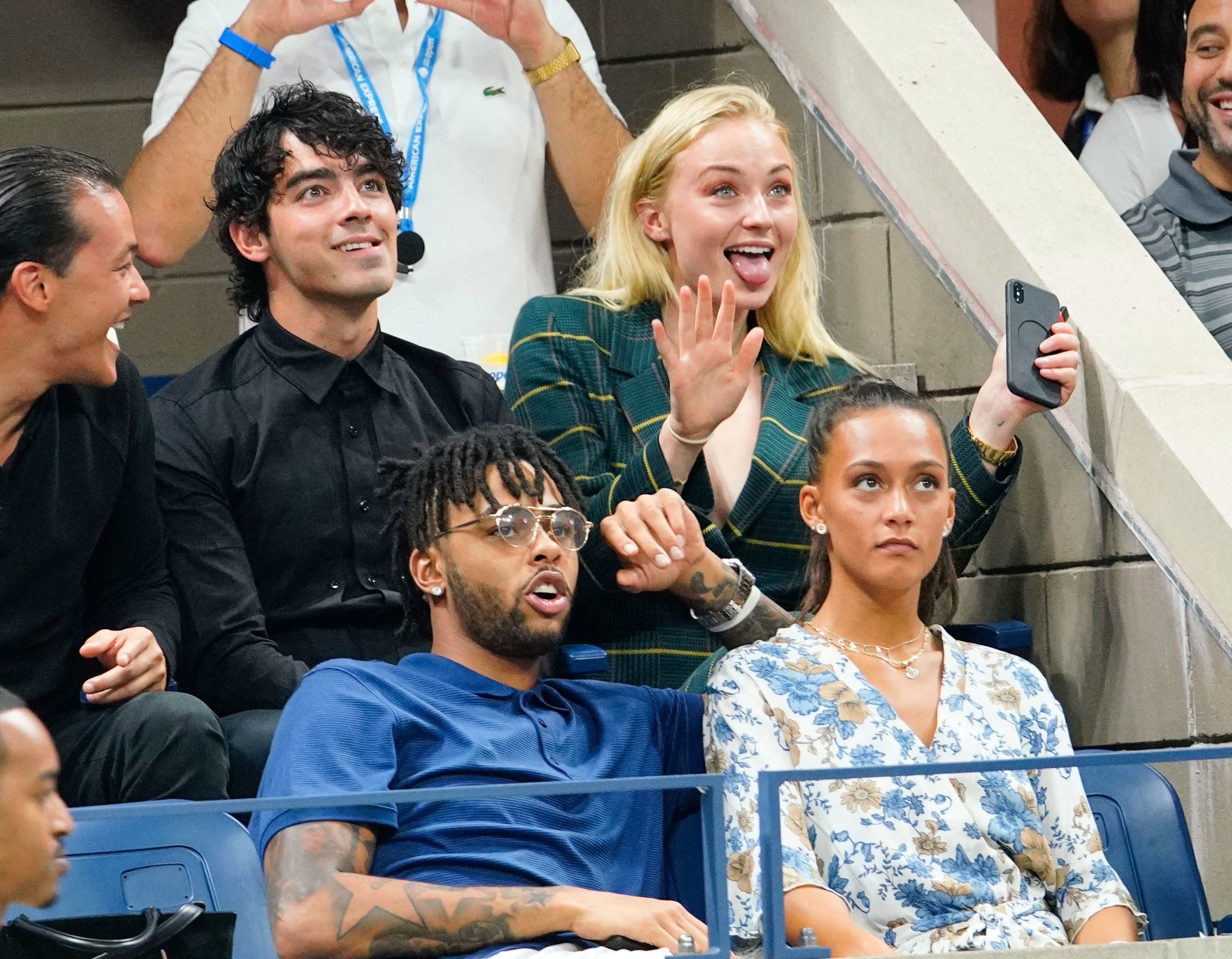 Sophie and Joe sitting together outdoors in an audience