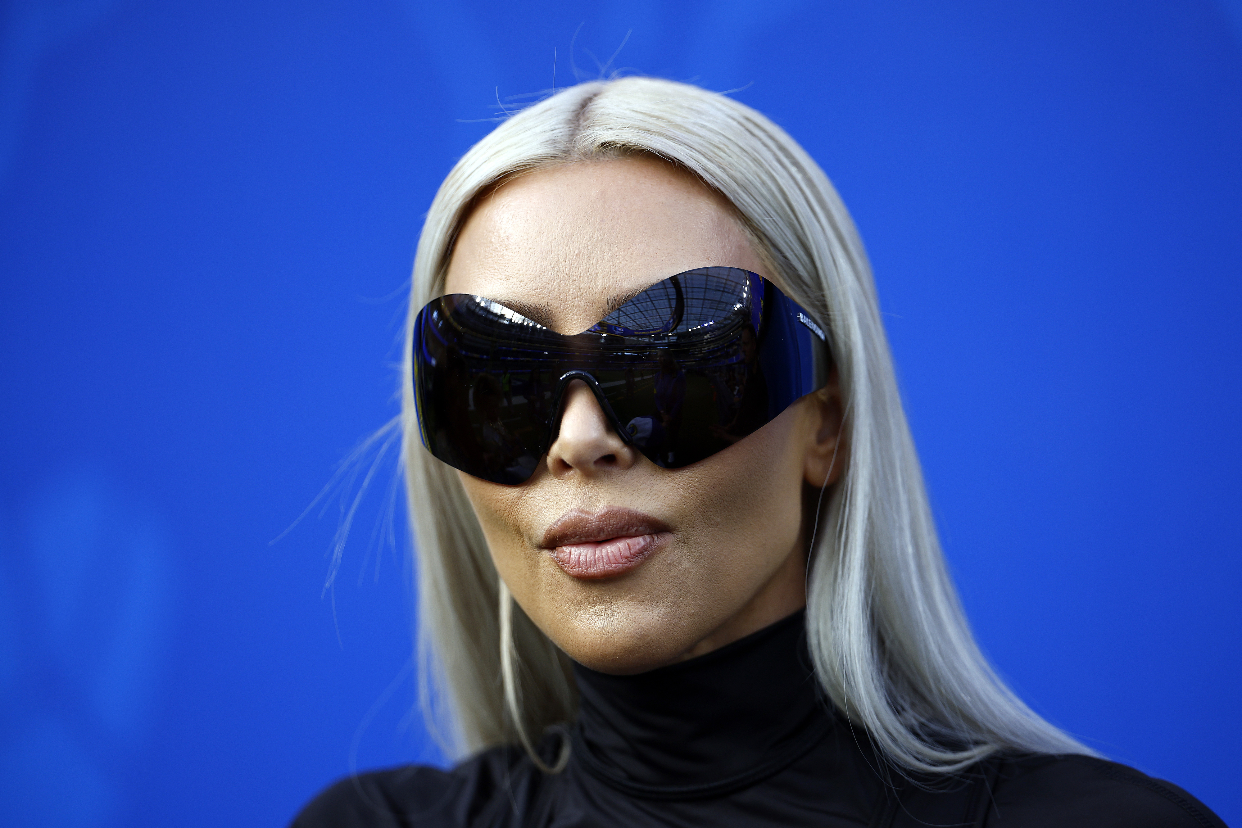 A closeup of Kim Kardashian in oversized sunglasses