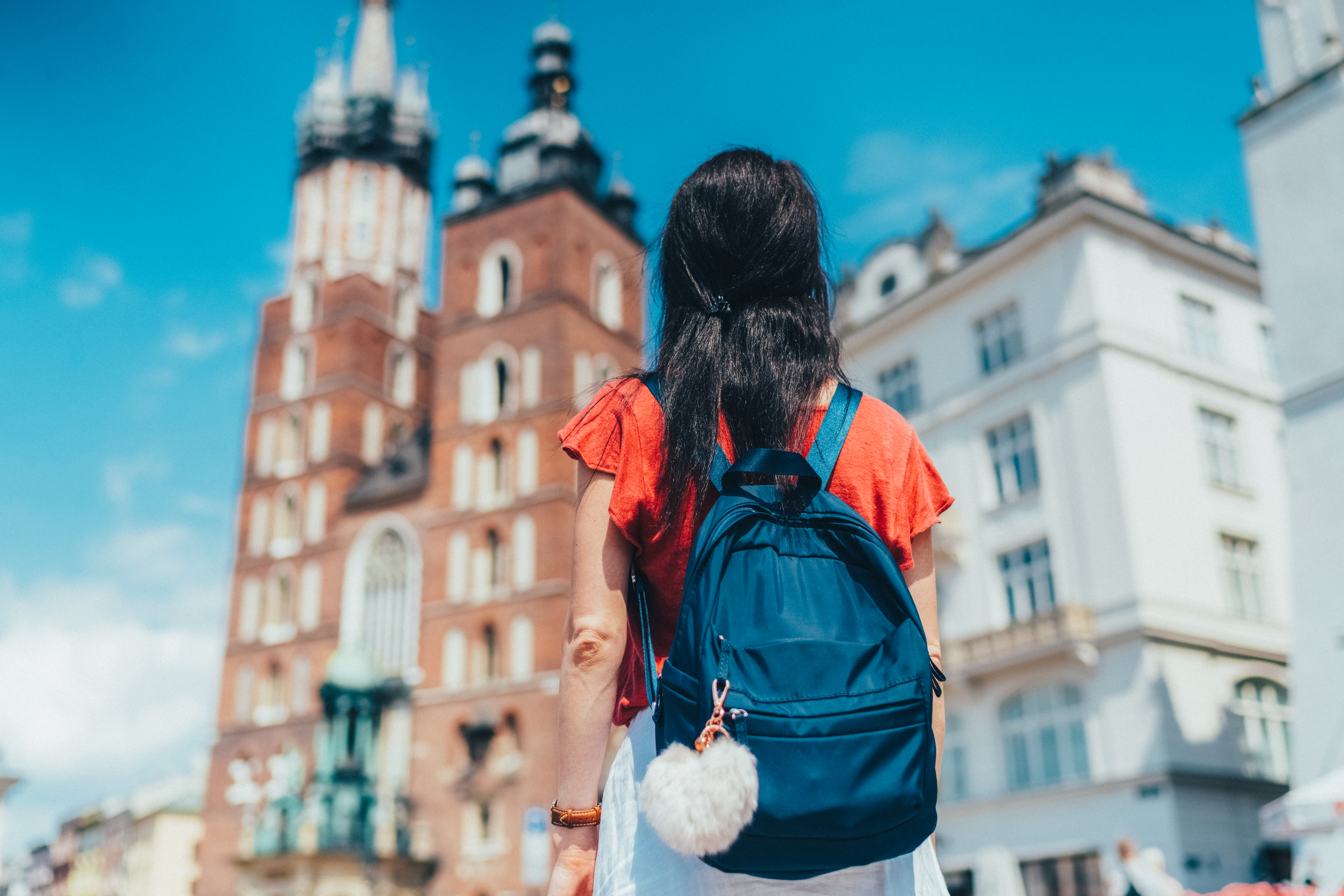 someone standing in a city center with a backpack on