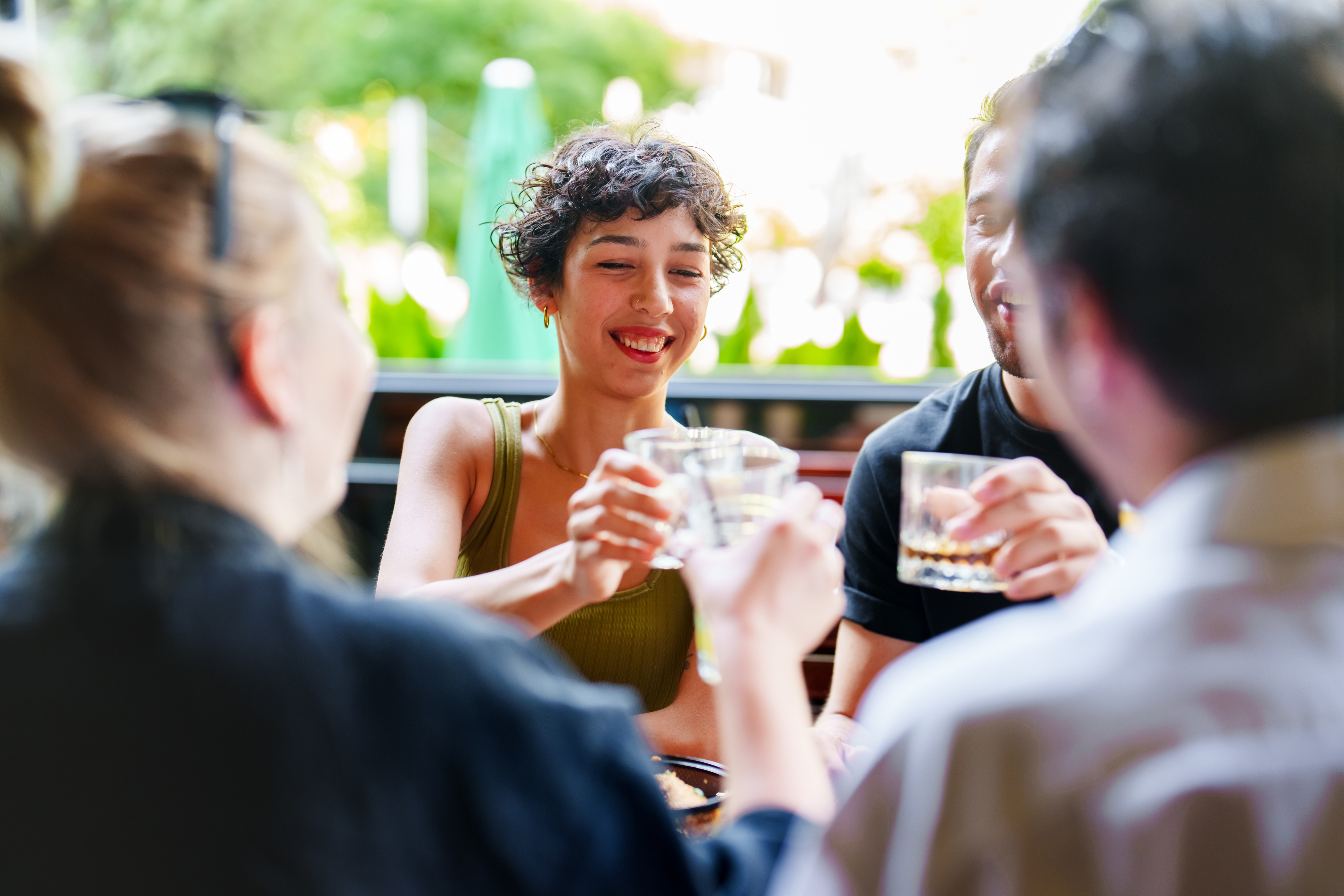 a group of people cheersing their drinks