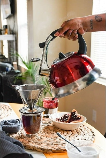 A red tea kettle pouring water
