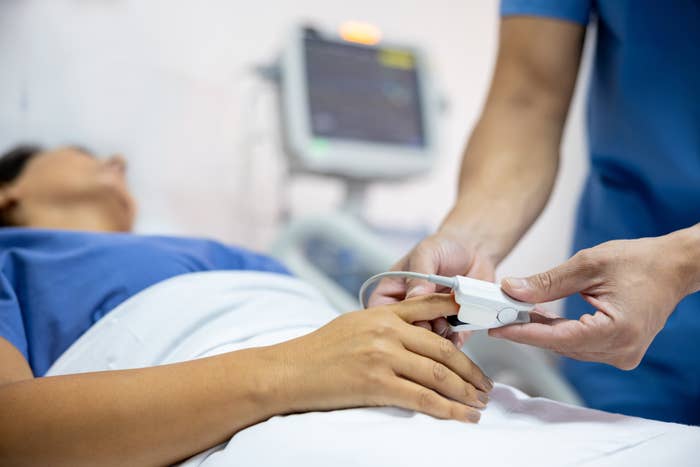 Close-up on a nurse placing a pulse oximeter on a patient at the hospital