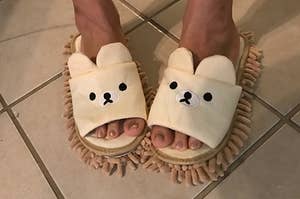 Reviewer wearing bear-shaped mop slippers