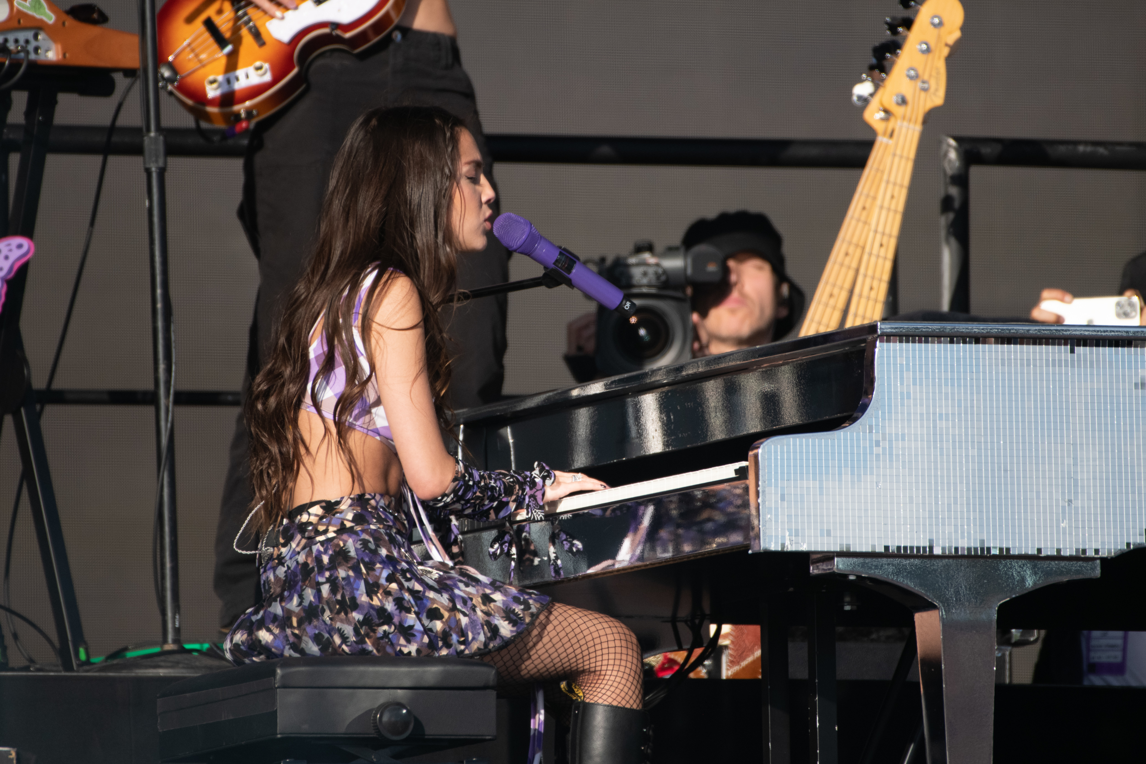 Olivia Rodrigo playing the piano and singing onstage