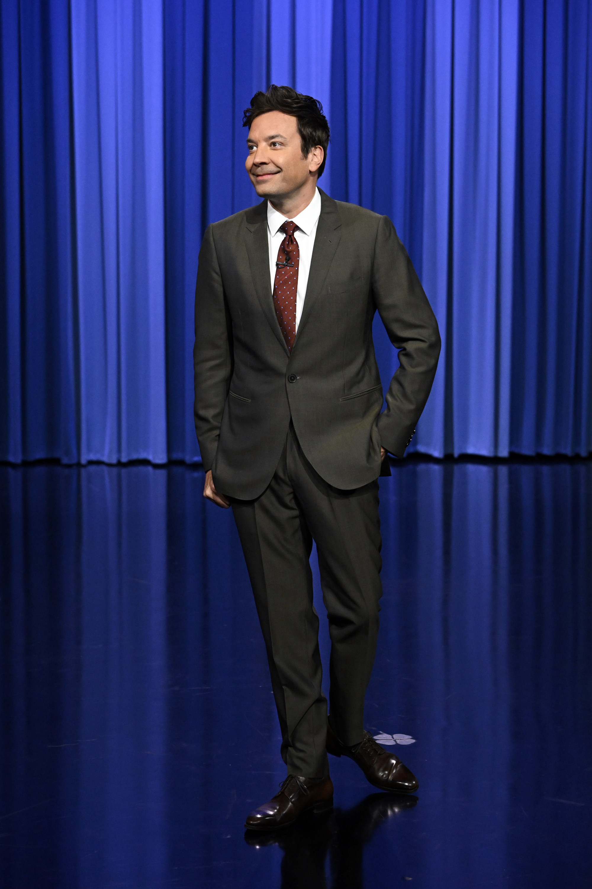 Jimmy Fallon stands on the stage of The Tonight Show