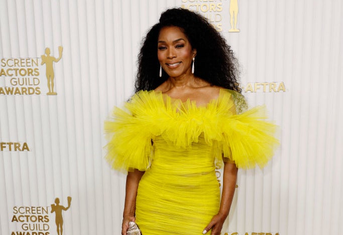 A closeup of Angela Basset on the red carpet of the Screen Actors Guild Awards wearing an off-the-shoulder chiffon dress