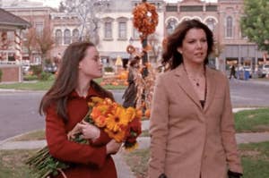 The Gilmore Girls walking through the town square.