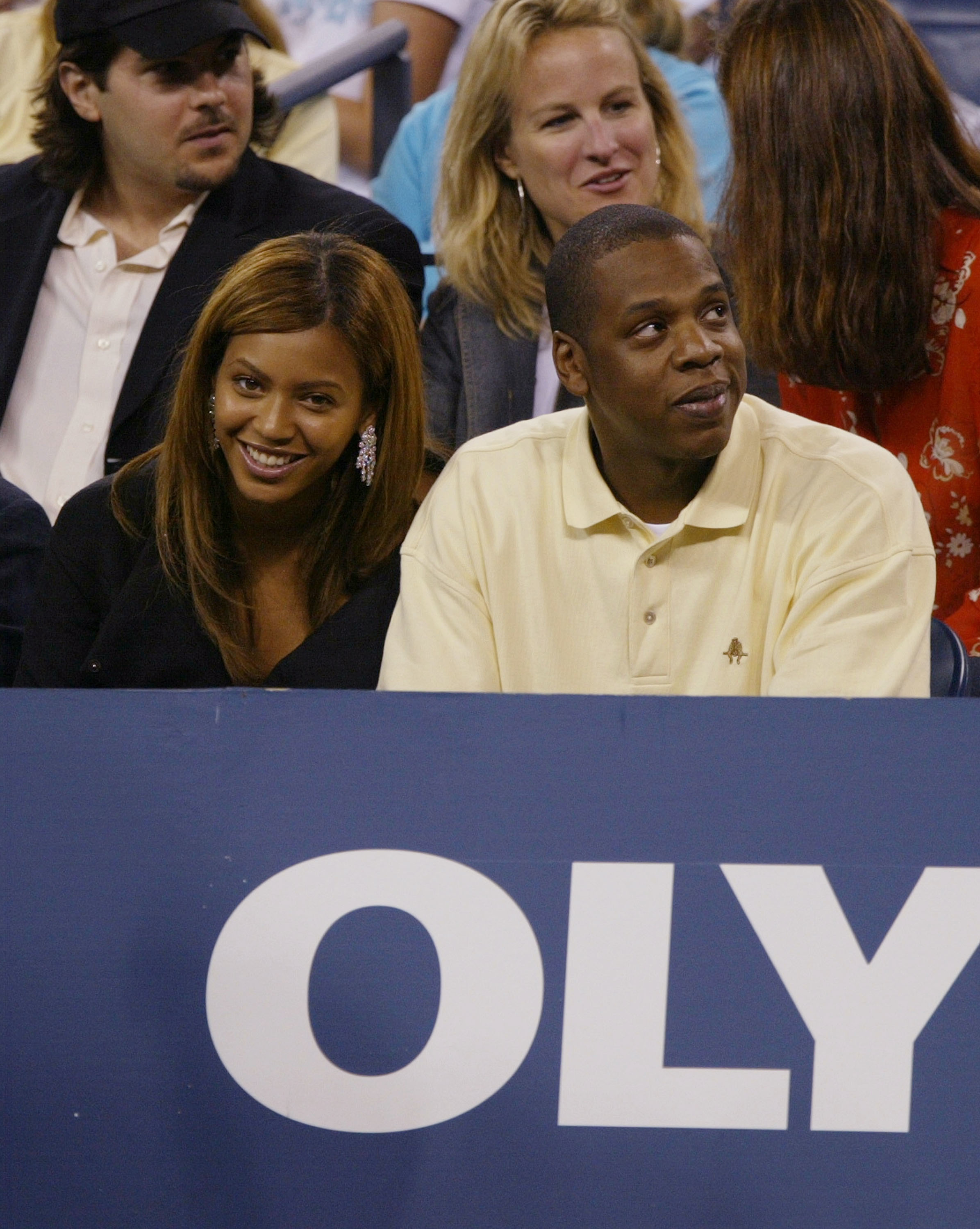 Beyoncé and Jay-Z sitting and smiling in the US Open stands