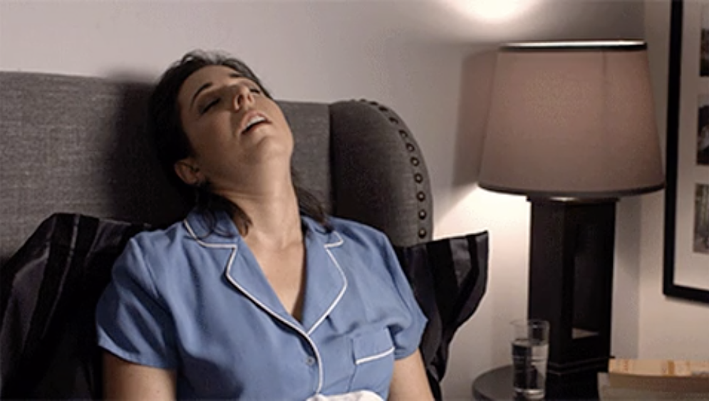 A woman is sleeping upright