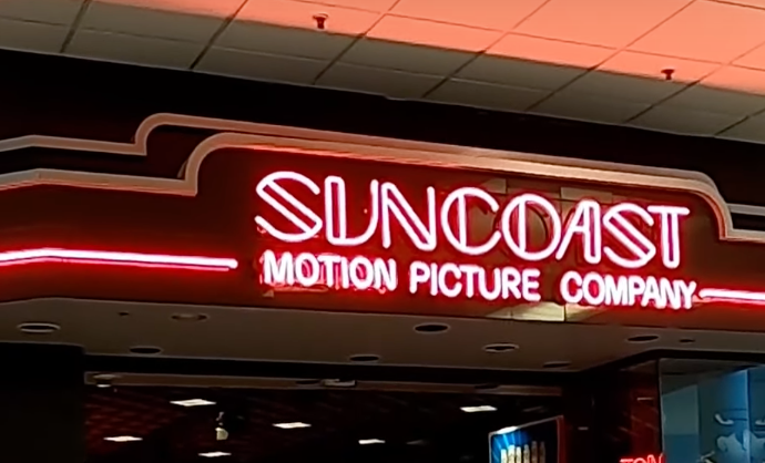 A Suncoast Motion Picture Company sign