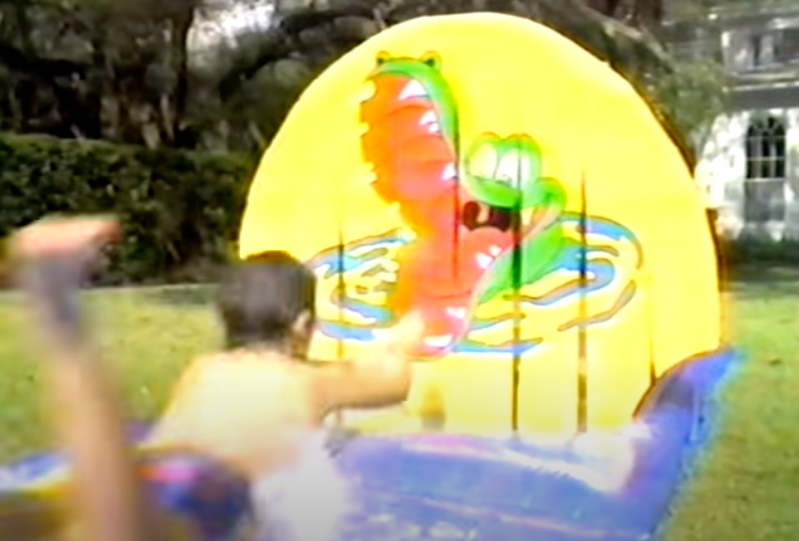 A kid using a slip-and-slide