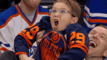 Little kid screaming in excitement at a hockey game