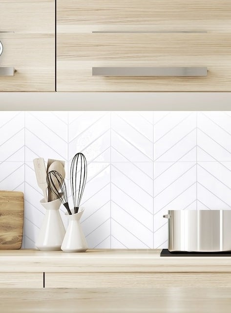 the white chevron tiles in a kitchen as a backsplash