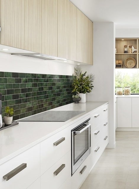 the green subway tiles in a kitchen as a backsplash