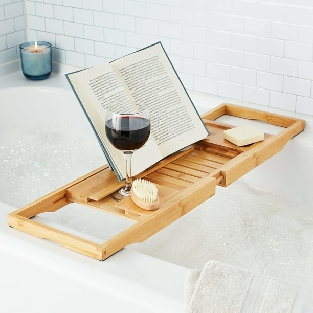 Bath tray holds a book and wine
