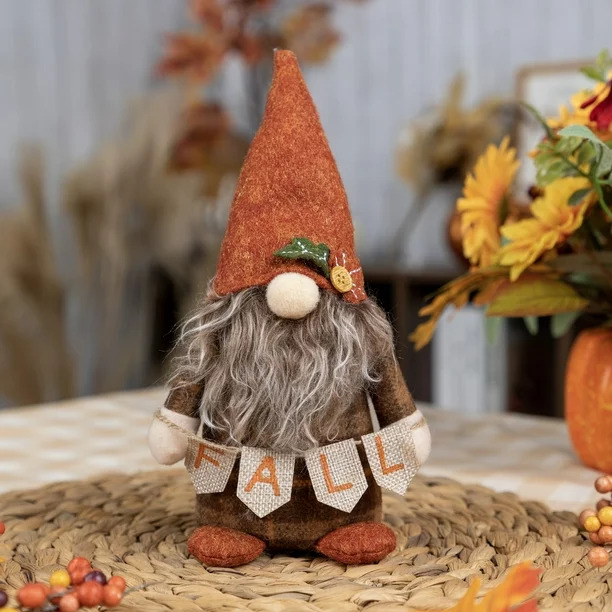 The gnome holding a sign that says fall