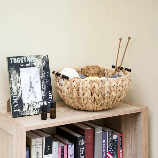 The decorative woven bowl with string in it on a bookshelf