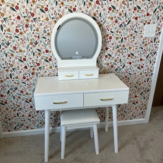 white vanity with two drawers, circle mirror, and matching stool